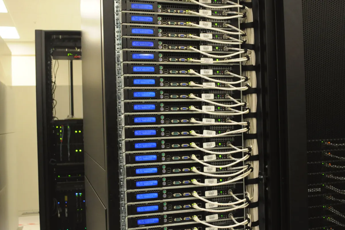 Cabled servers at the back of a rack in a server room